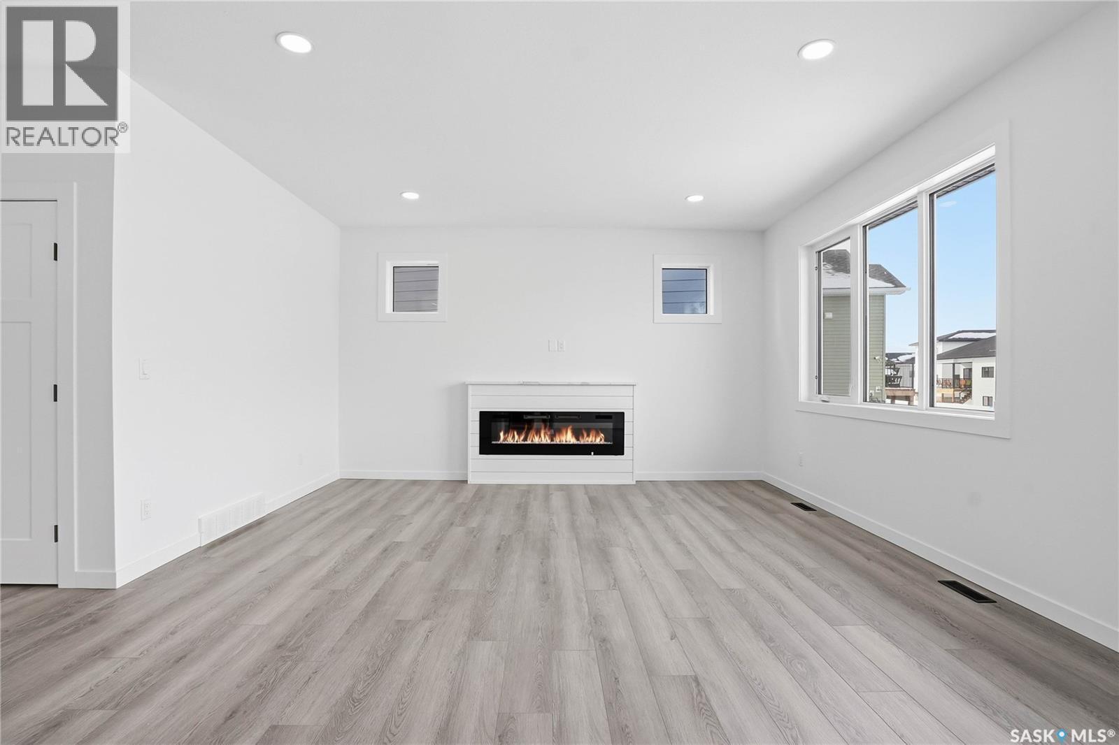 139 Sharma Lane, Saskatoon, SK - Indoor Photo Showing Living Room With Fireplace