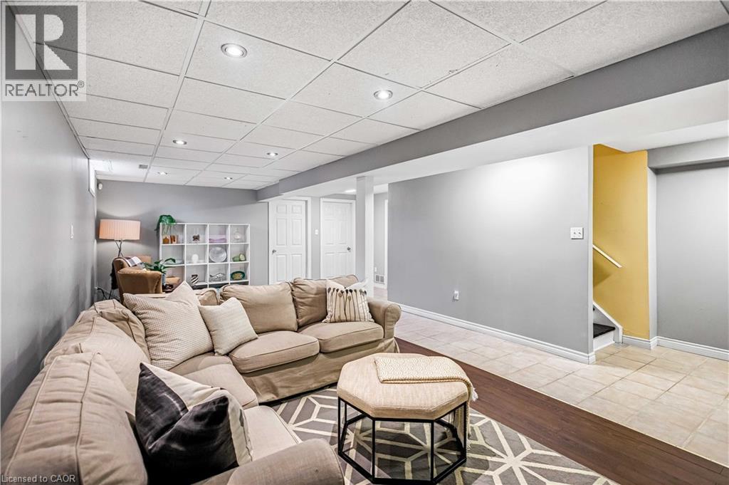 Living area featuring a paneled ceiling, wood finished floors, and recessed lighting - 65 Thistlemoor Drive, Caledonia, ON - Indoor Photo Showing Living Room