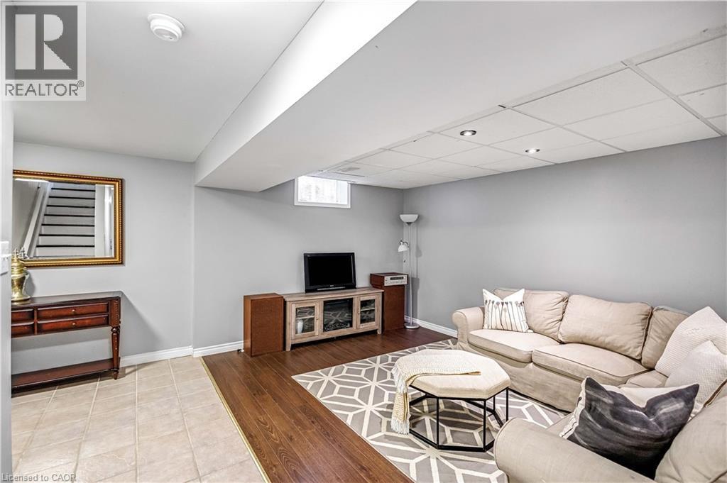 Living area with light wood-style floors and a paneled ceiling - 65 Thistlemoor Drive, Caledonia, ON - Indoor Photo Showing Other Room