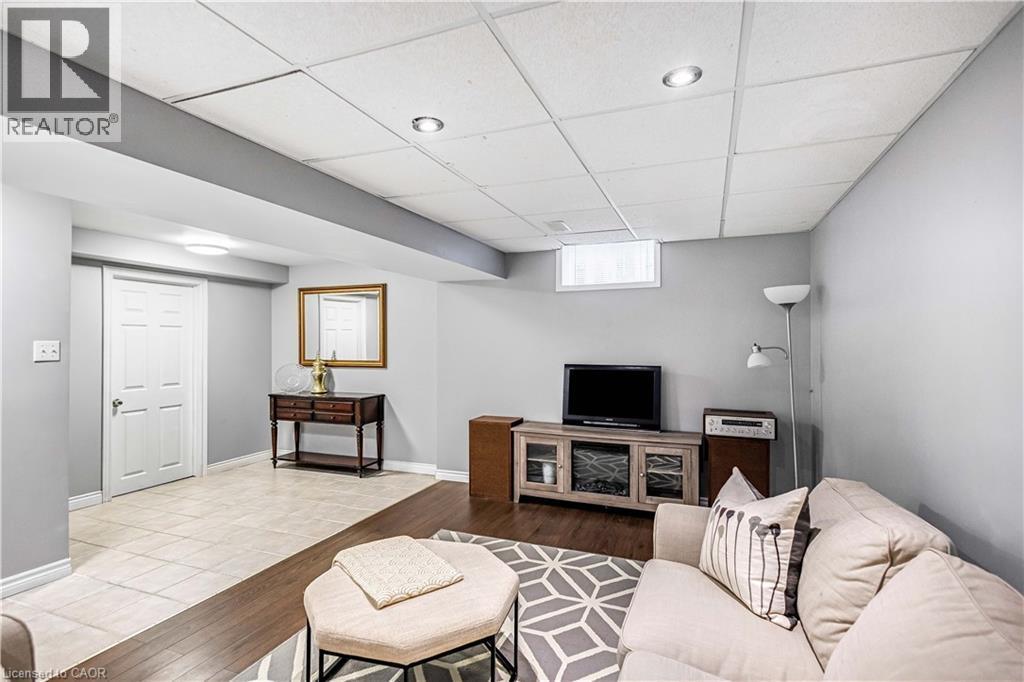 Living area with a paneled ceiling and wood finished floors - 65 Thistlemoor Drive, Caledonia, ON - Indoor Photo Showing Other Room