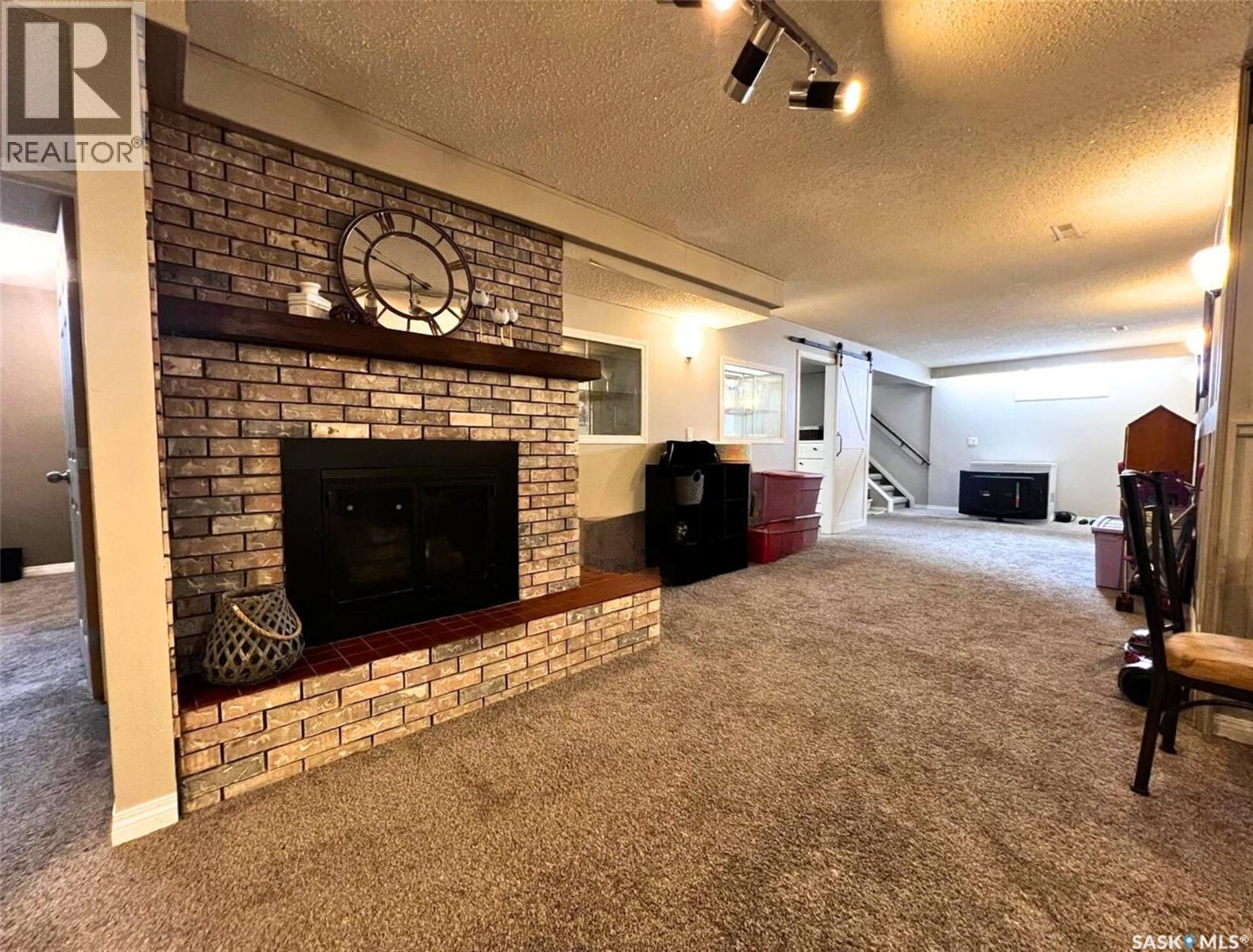 119 Macdonald Place, Swift Current, SK - Indoor Photo Showing Living Room With Fireplace