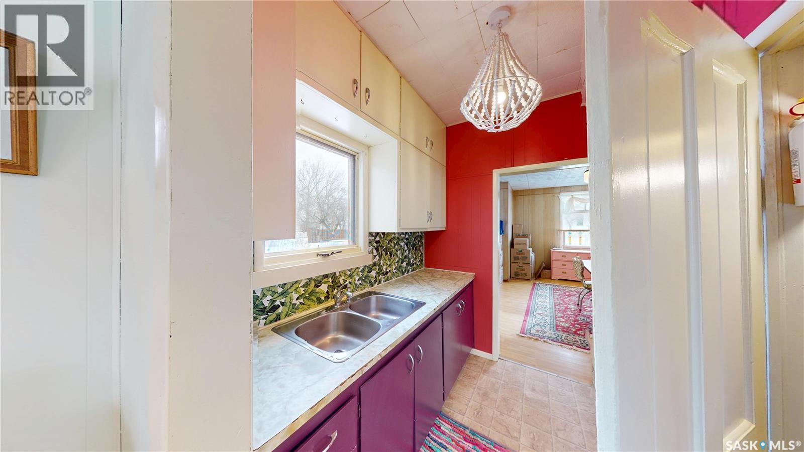107 3Rd Avenue, Scott, SK - Indoor Photo Showing Kitchen With Double Sink
