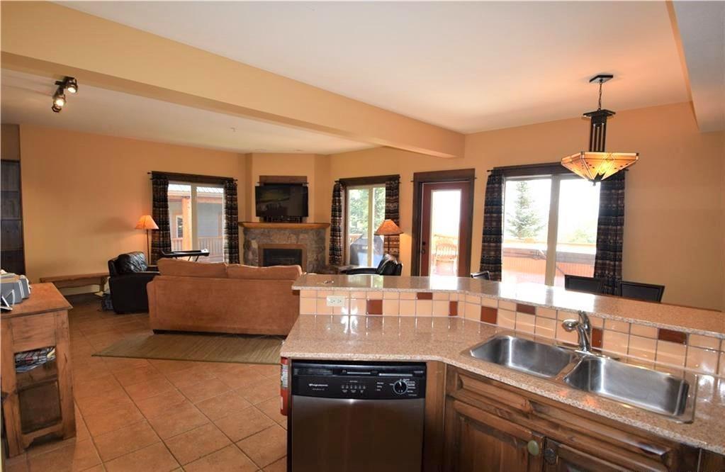 D2-B-1351 Gerry Sorensen Way, Kimberley, BC - Indoor Photo Showing Kitchen With Fireplace With Double Sink