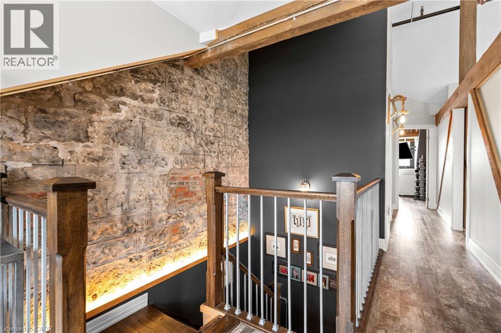 Hallway featuring dark wood-style floors, an upstairs landing, and vaulted ceiling - 25 Concession Street Unit# 201, Cambridge, ON - Indoor Photo Showing Other Room