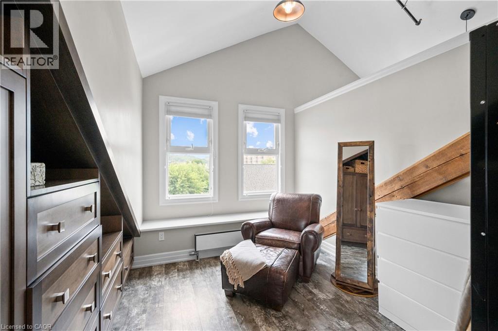 Living area with dark wood-style floors and lofted ceiling - 25 Concession Street Unit# 201, Cambridge, ON - Indoor