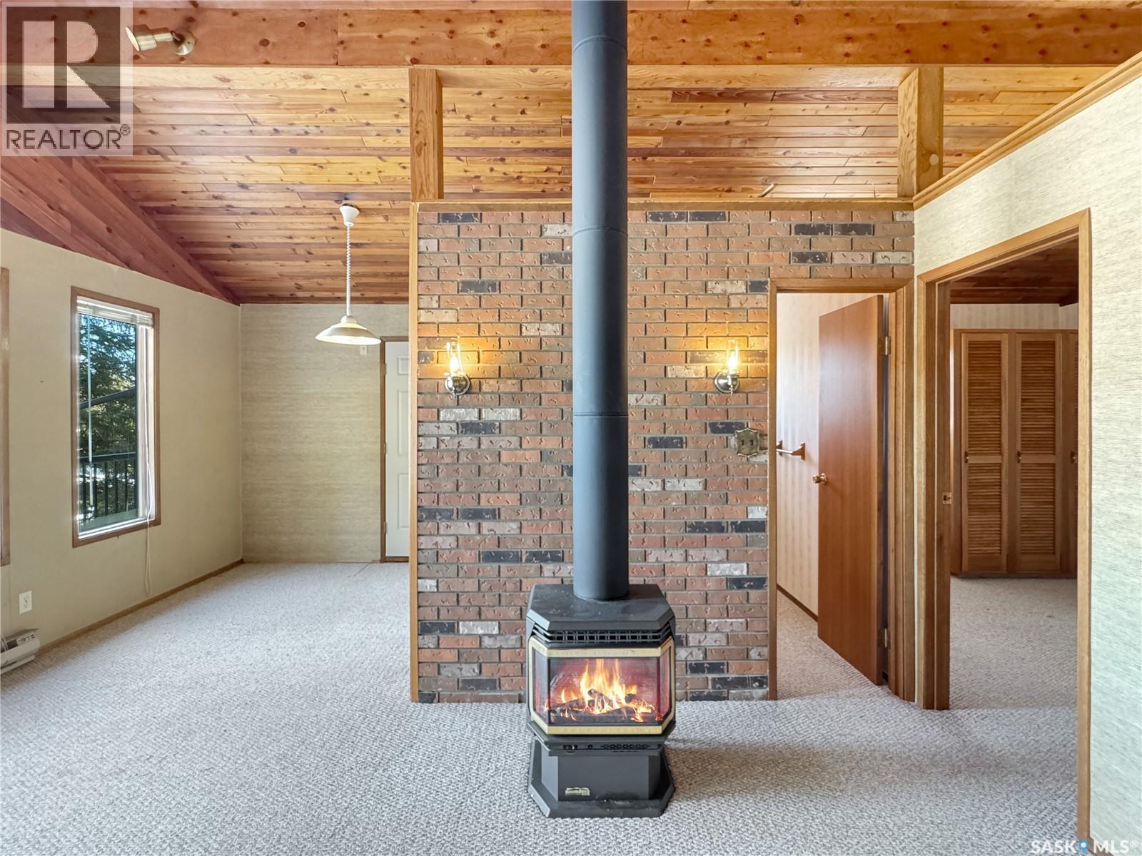 102 Lakeshore Drive, Echo Bay, SK - Indoor Photo Showing Other Room With Fireplace
