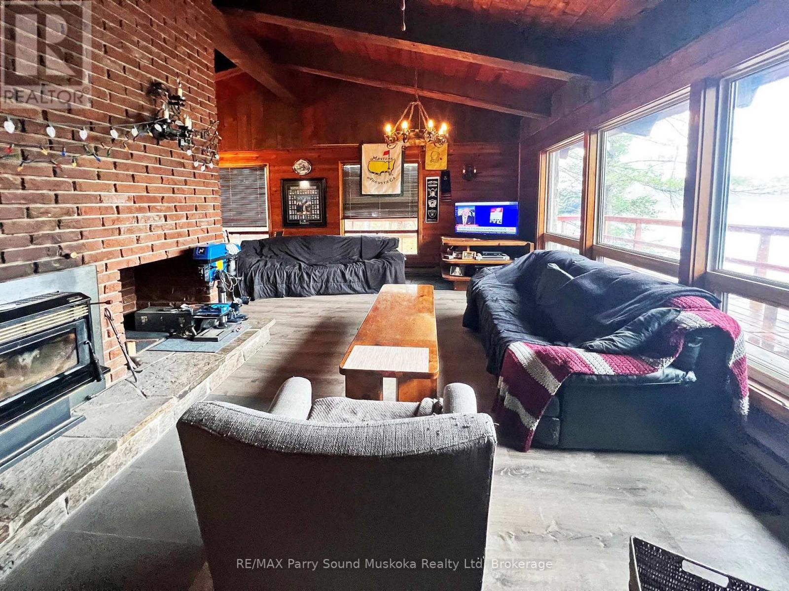 Living room w fireplace - 45 Ridgeway Drive, Carling, ON - Indoor Photo Showing Living Room With Fireplace
