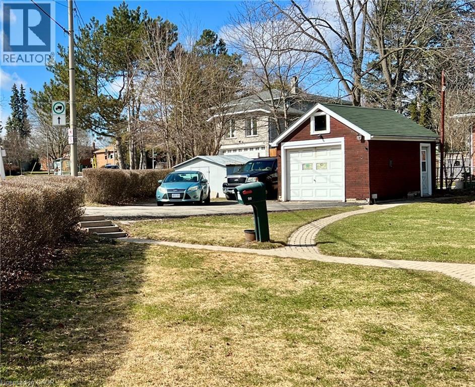 View of side yard with driveway, a garage, paver walkway and a large shed - 90 Osler Drive, Dundas, ON - Outdoor