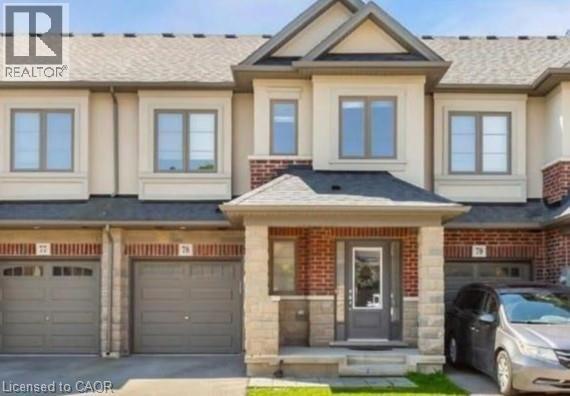 View of front facade featuring a garage, driveway, covered porch, and brick siding - 324 Equestrian Way Unit# 78, Cambridge, ON - Outdoor With Facade