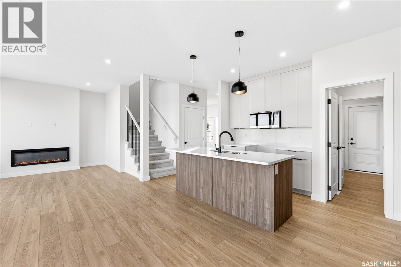 283 Nazarali Way, Saskatoon, SK - Indoor Photo Showing Kitchen With Fireplace