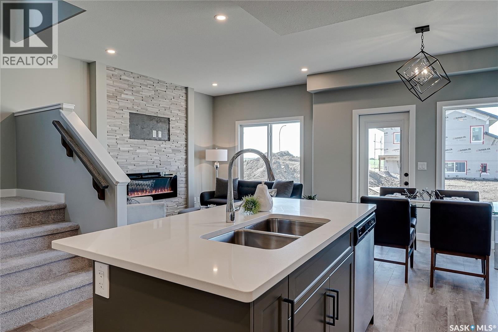 570 Traeger Manor, Saskatoon, SK - Indoor Photo Showing Kitchen With Fireplace With Double Sink
