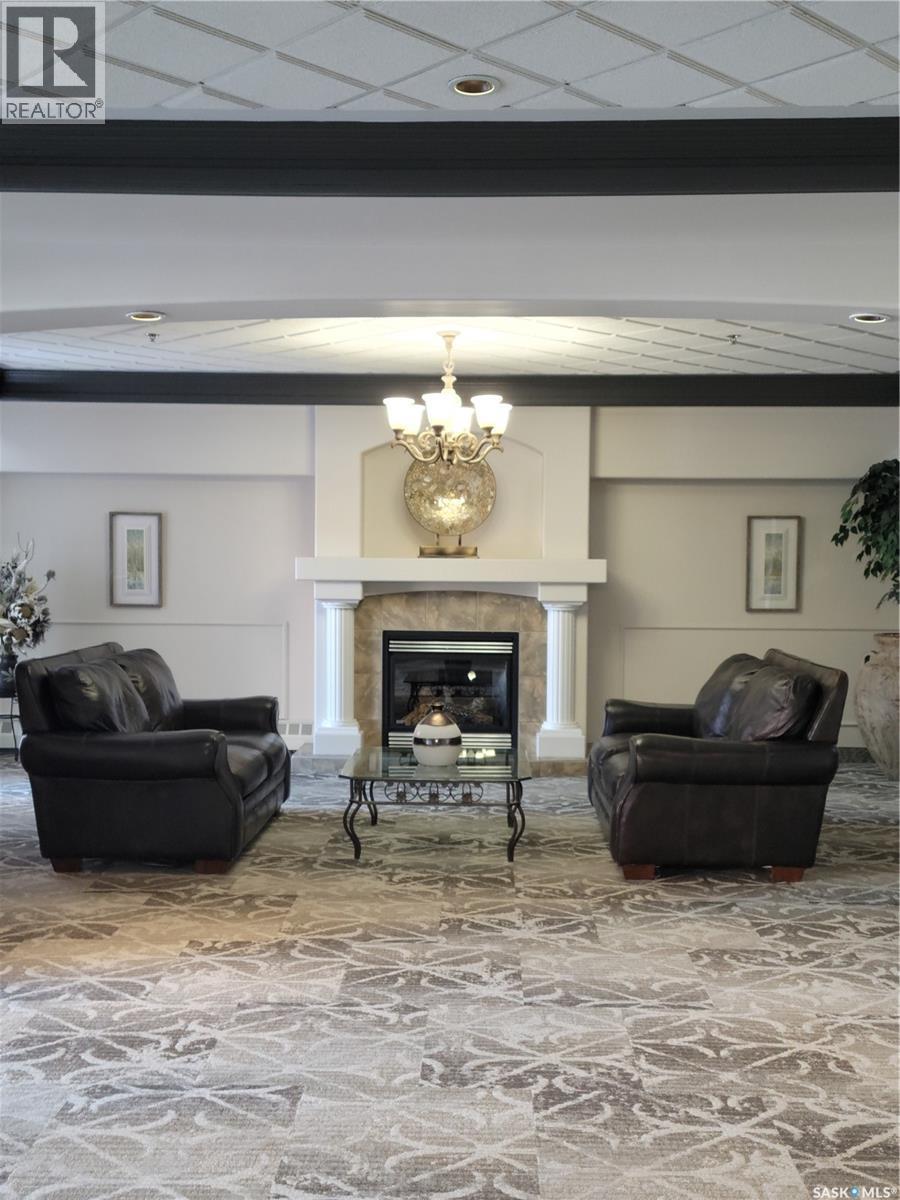 304 928 Heritage View, Saskatoon, SK - Indoor Photo Showing Other Room With Fireplace