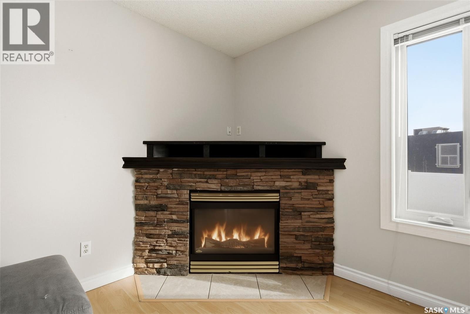 1368 Maple Leaf Crescent N, Regina, SK - Indoor Photo Showing Living Room With Fireplace