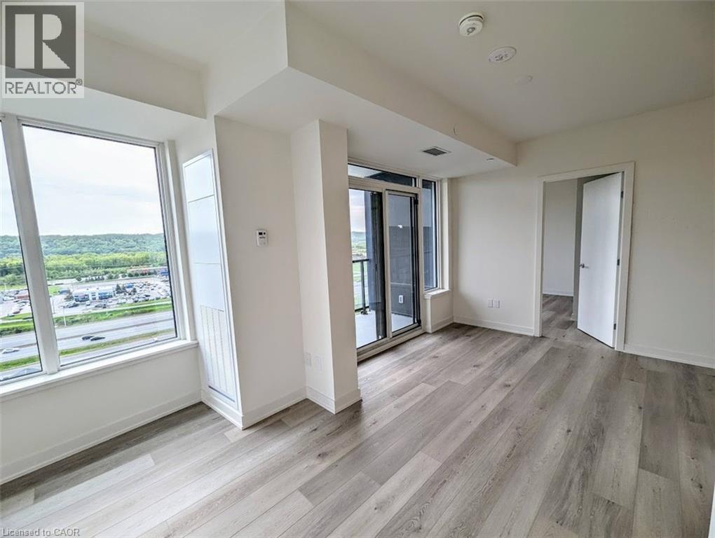 Spare room featuring light wood-style floors - 385 Winston Road Unit# 1311, Grimsby, ON - Indoor Photo Showing Other Room