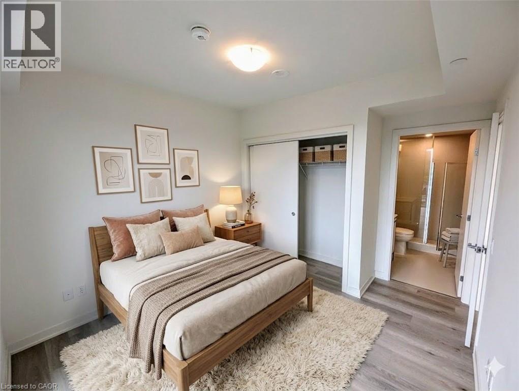 Bedroom with a closet and light wood-type flooring - 385 Winston Road Unit# 1311, Grimsby, ON - Indoor Photo Showing Bedroom