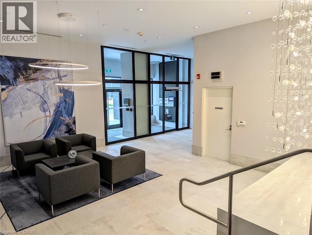 Community lobby with expansive windows and recessed lighting - 385 Winston Road Unit# 1311, Grimsby, ON - Indoor Photo Showing Other Room