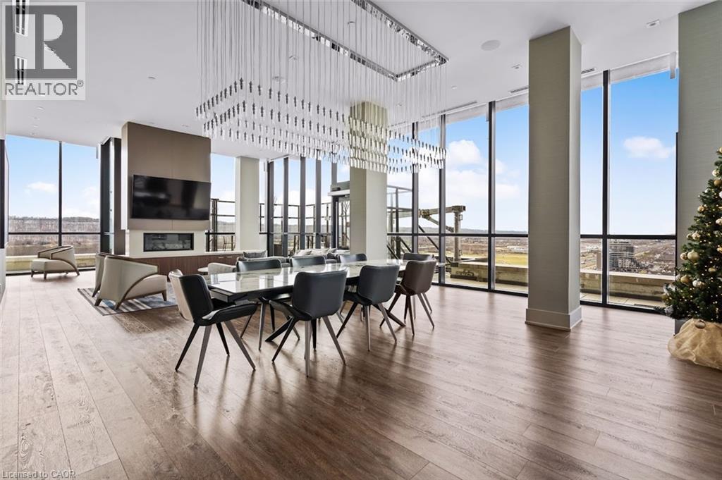 Dining room featuring floor to ceiling windows and dark wood finished floors - 385 Winston Road Unit# 1311, Grimsby, ON - Indoor
