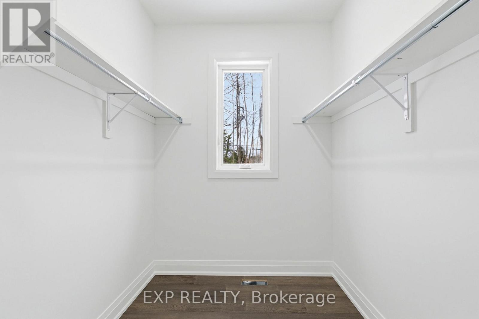 Primary bedroom walk-in closet w/ window - 49 Beaufort Crescent, Tiny, ON - Indoor With Storage