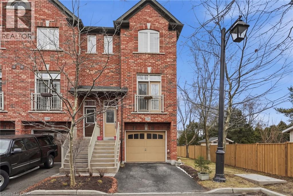 View of front of home featuring brick siding, driveway, and a garage - 2358 Treversh Common, Burlington, ON - Outdoor
