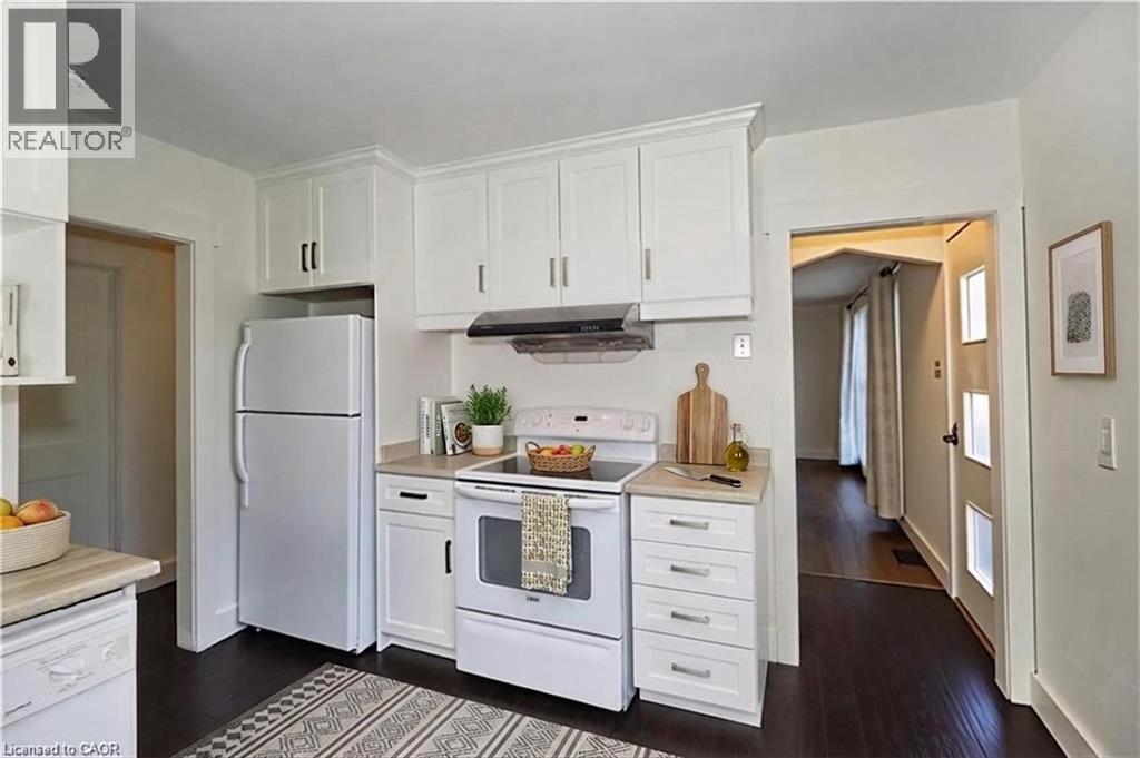 Kitchen featuring white appliances, white cabinetry, light countertops, and ventilation hood - 49 Dietz Avenue S, Waterloo, ON - Indoor Photo Showing Kitchen