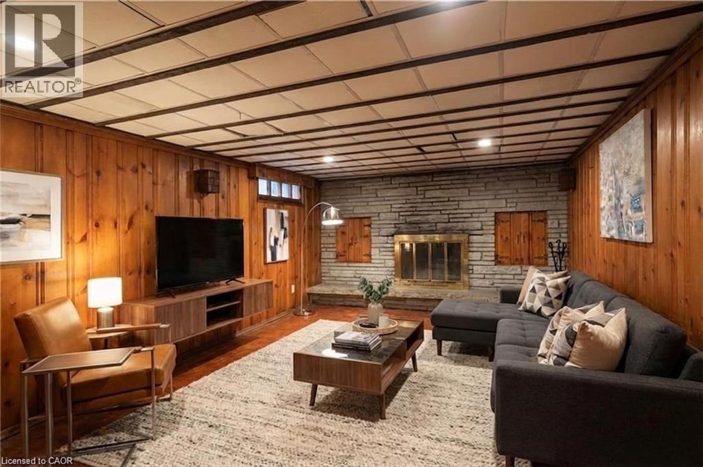 Virtually staged basement family room - 49 Dietz Avenue S, Waterloo, ON - Indoor Photo Showing Living Room With Fireplace