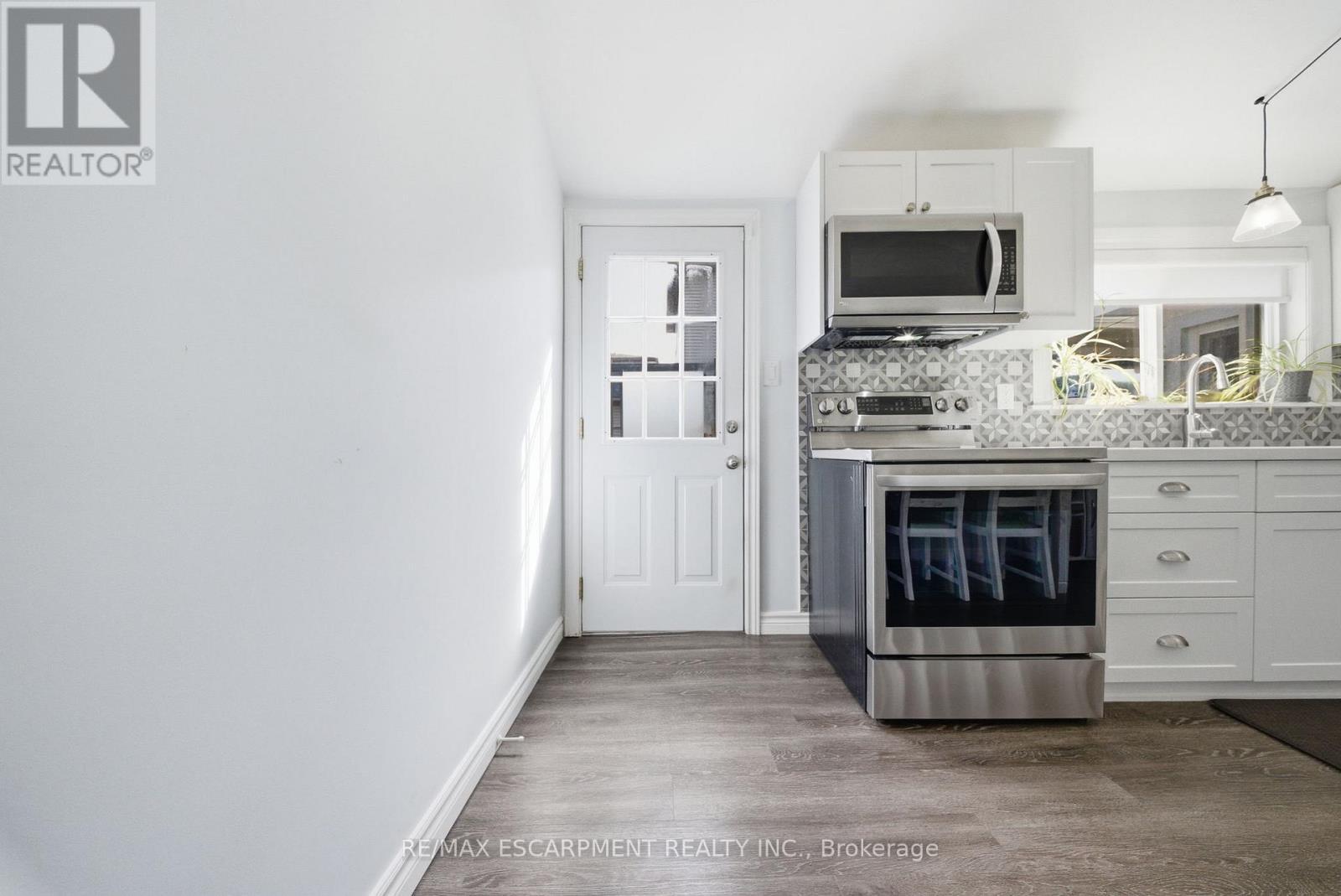 Door to deck off kitchen - 36 Queensdale Avenue W, Hamilton, ON - Indoor Photo Showing Kitchen With Upgraded Kitchen