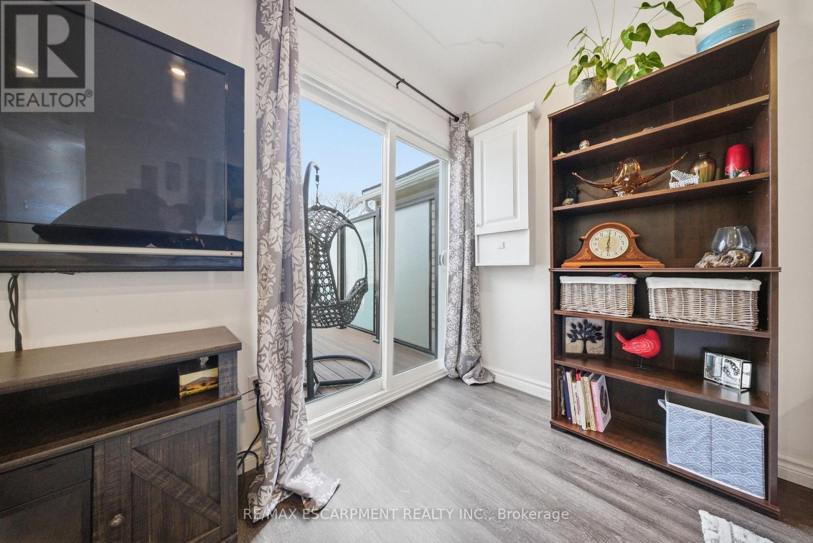 sliding door to deck off living room - 36 Queensdale Avenue W, Hamilton, ON - Indoor Photo Showing Other Room
