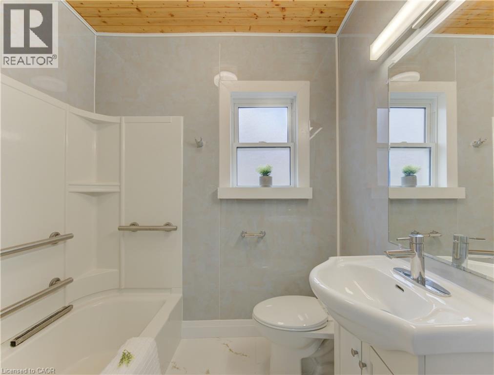 Bathroom featuring vanity, wooden ceiling, and tub / shower combination - 171 Sixth Avenue, Kitchener, ON - Indoor Photo Showing Bathroom