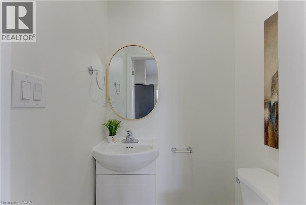 Half bath featuring toilet and a sink - 171 Sixth Avenue, Kitchener, ON - Indoor Photo Showing Bathroom