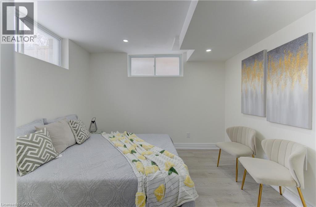 Bedroom featuring recessed lighting, light wood finished floors, and multiple windows - 171 Sixth Avenue, Kitchener, ON - Indoor