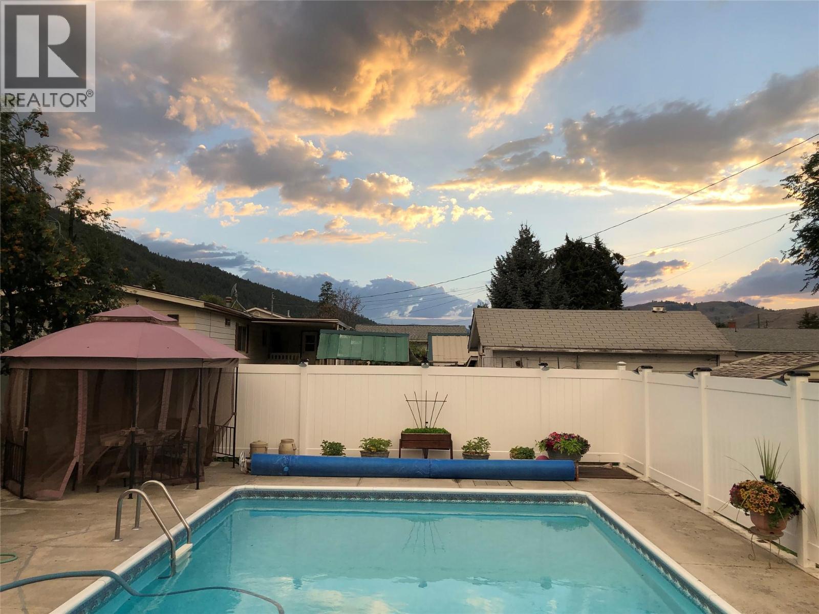461 Eighth Avenue, Midway, BC - Outdoor With In Ground Pool With Deck Patio Veranda With View