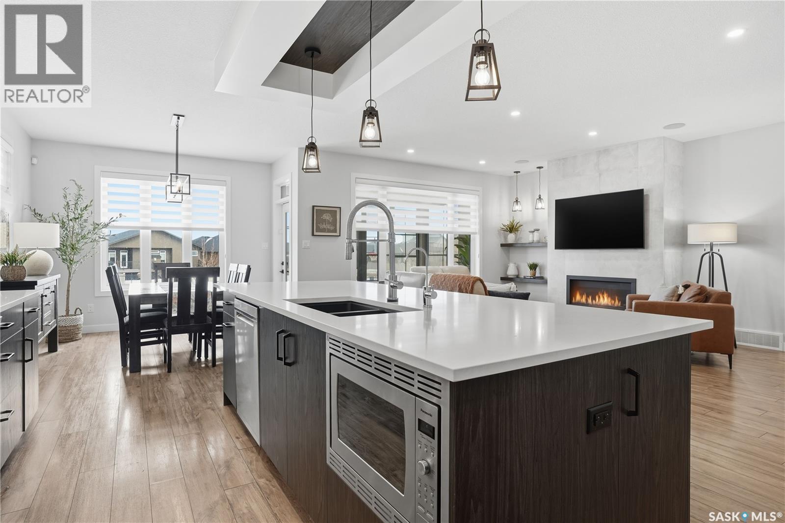 4418 Sage Crescent E, Regina, SK - Indoor Photo Showing Kitchen With Fireplace With Double Sink With Upgraded Kitchen