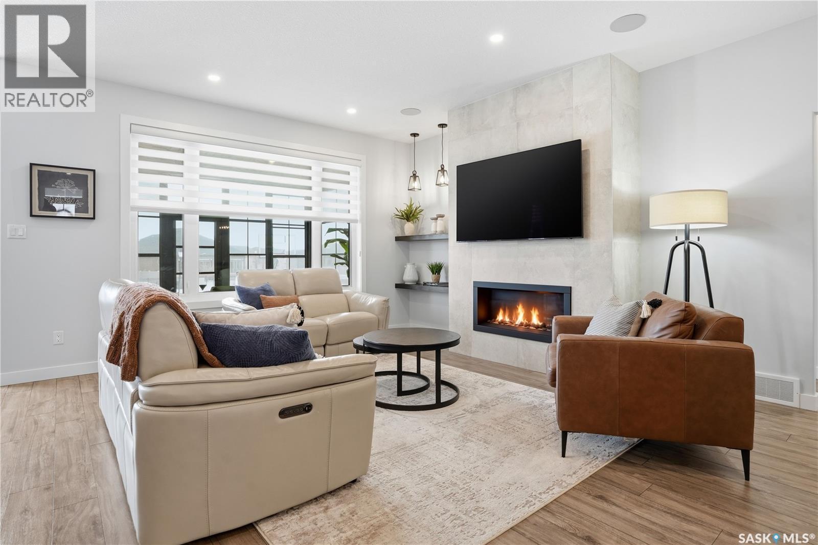 4418 Sage Crescent E, Regina, SK - Indoor Photo Showing Living Room With Fireplace