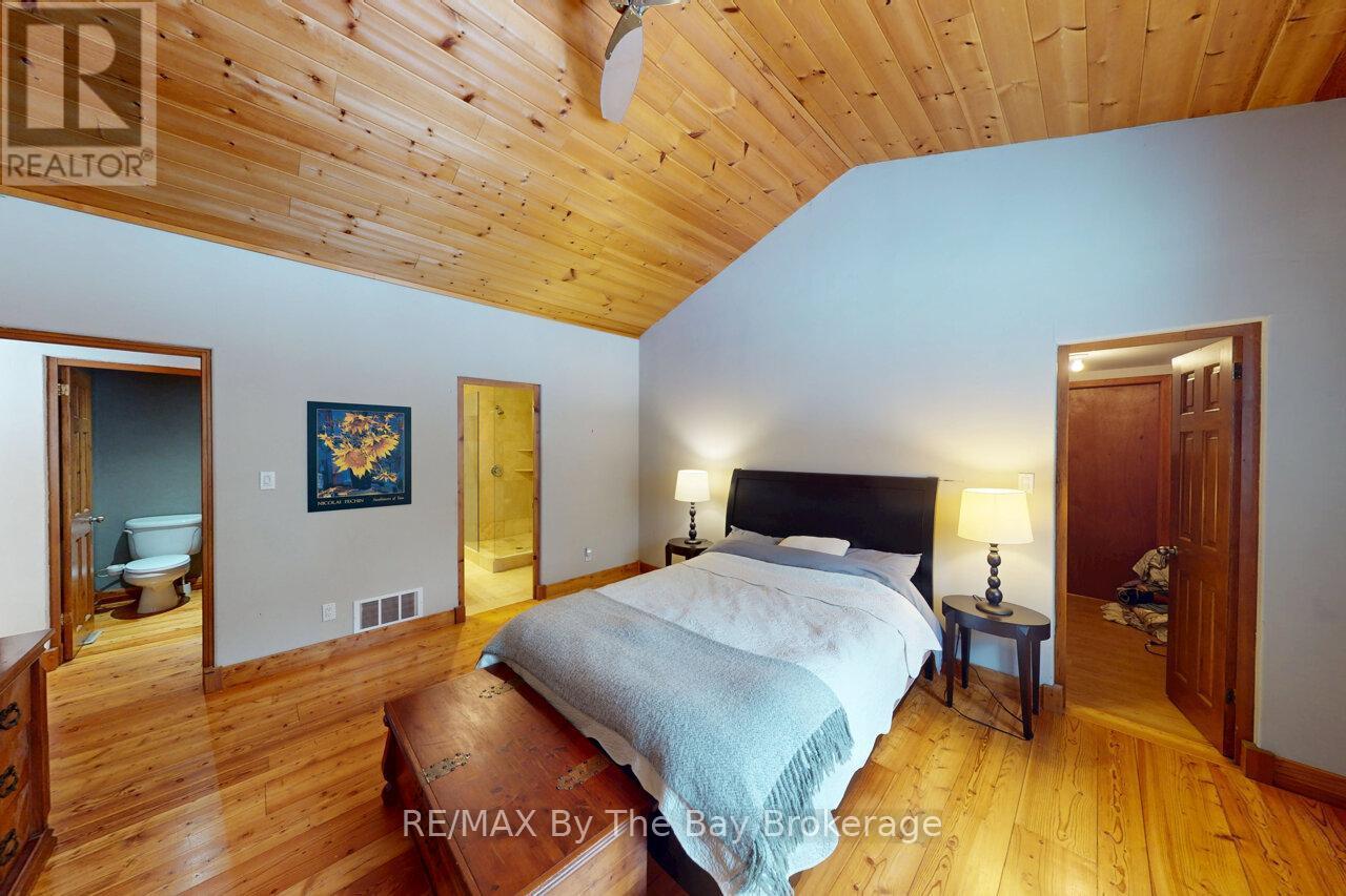 Primary Bedroom with walk in closet and wine room - 397 Silver Birch Drive, Tiny, ON - Indoor Photo Showing Bedroom