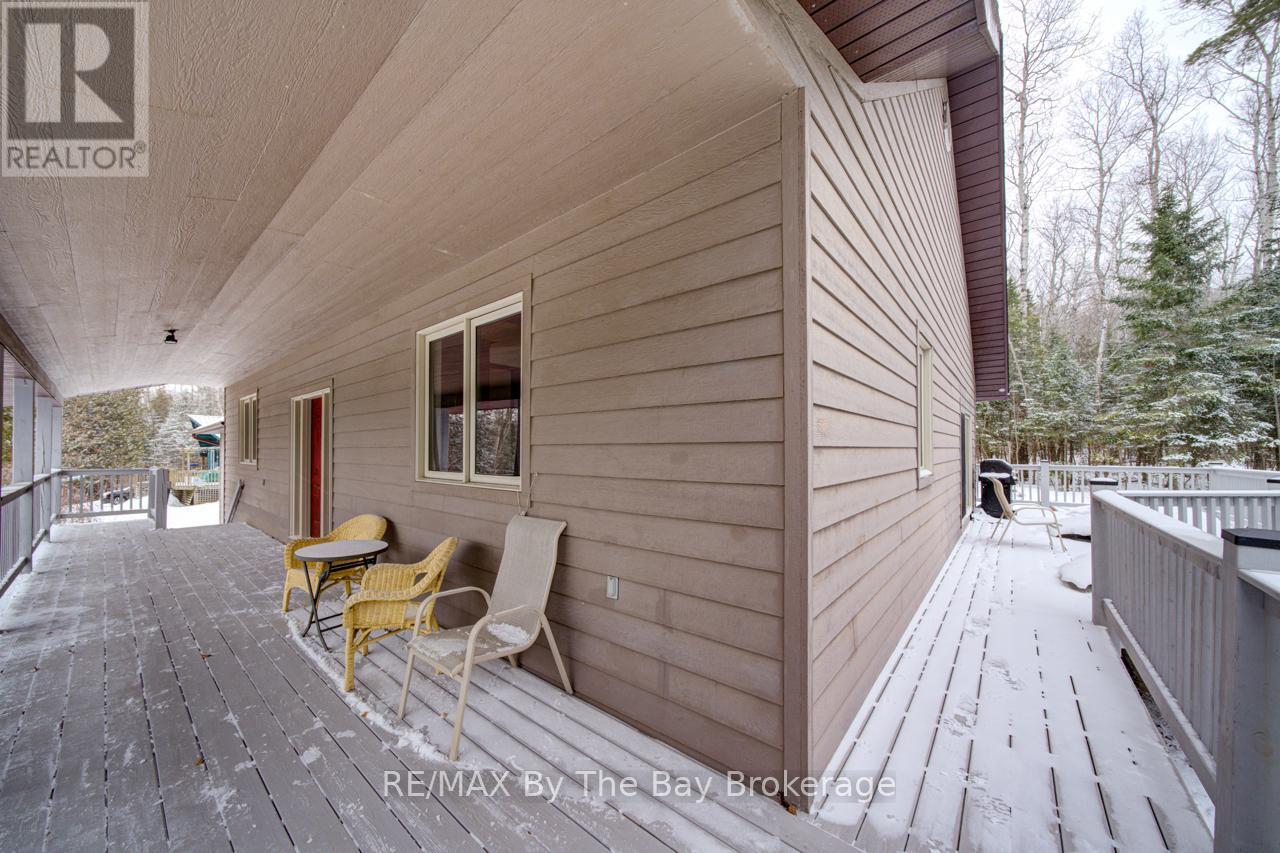 Porch wraps around 3 Sides - 397 Silver Birch Drive, Tiny, ON - Outdoor With Deck Patio Veranda With Exterior