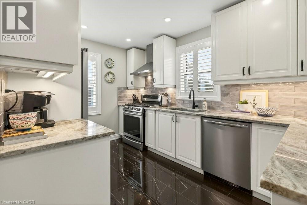 Kitchen with white cabinetry, light stone counters, and recessed lighting - 237 East 32Nd Street, Hamilton, ON - Indoor Photo Showing Kitchen With Upgraded Kitchen