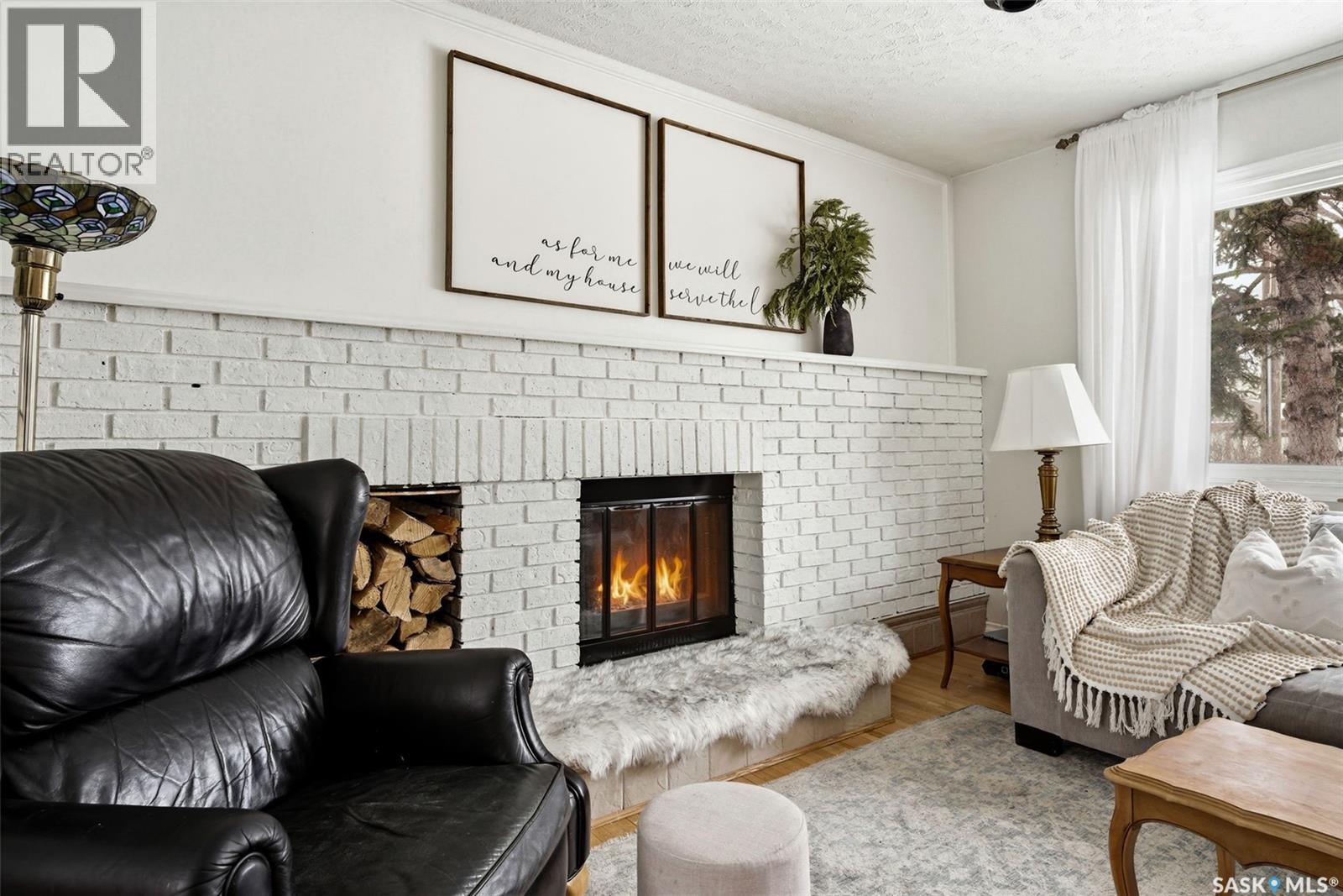 18 Marsh Crescent, Regina, SK - Indoor Photo Showing Living Room With Fireplace
