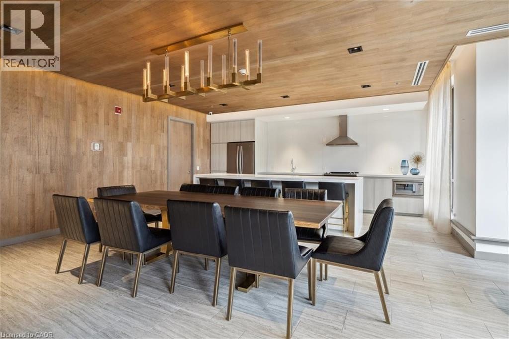 Dining room featuring wooden ceiling, light wood-style floors, and wooden walls - 40 Esplanade Lane Unit# 102, Grimsby, ON - Indoor Photo Showing Dining Room