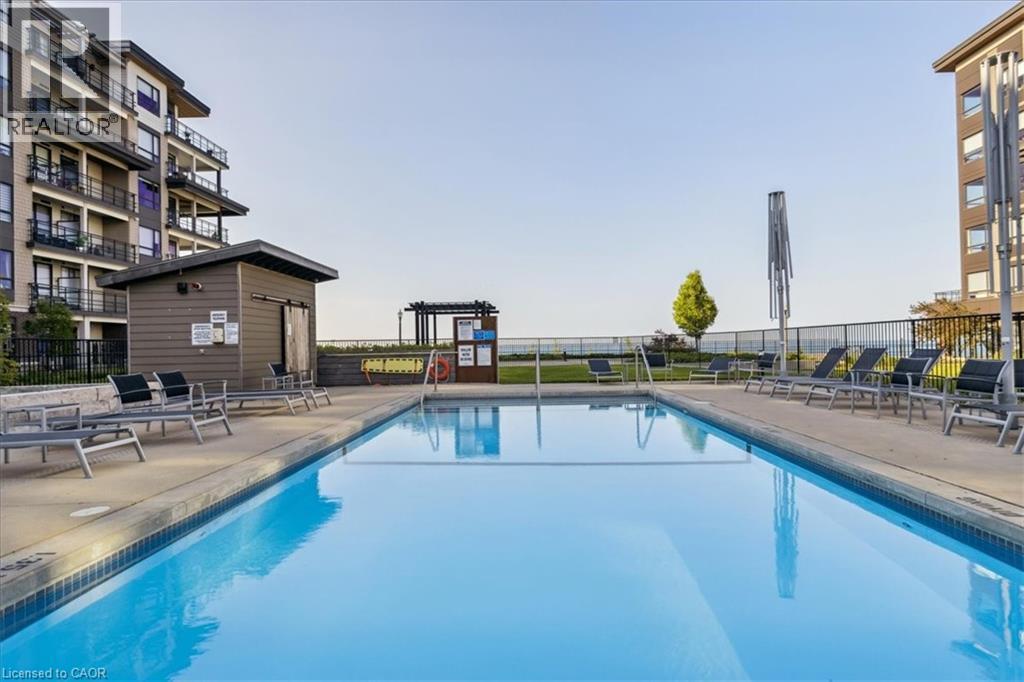 Community pool with a patio - 40 Esplanade Lane Unit# 102, Grimsby, ON - Outdoor With In Ground Pool