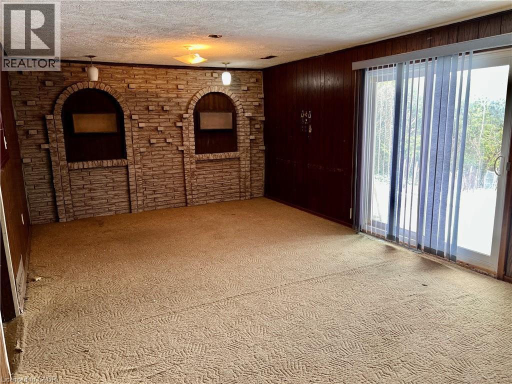 Gas fireplace, walkout to rear yard and patio - 185 Lavina Crescent, Hamilton, ON - Indoor Photo Showing Other Room