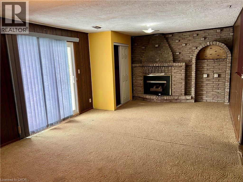 Walk out to rear patio - 185 Lavina Crescent, Hamilton, ON - Indoor With Fireplace