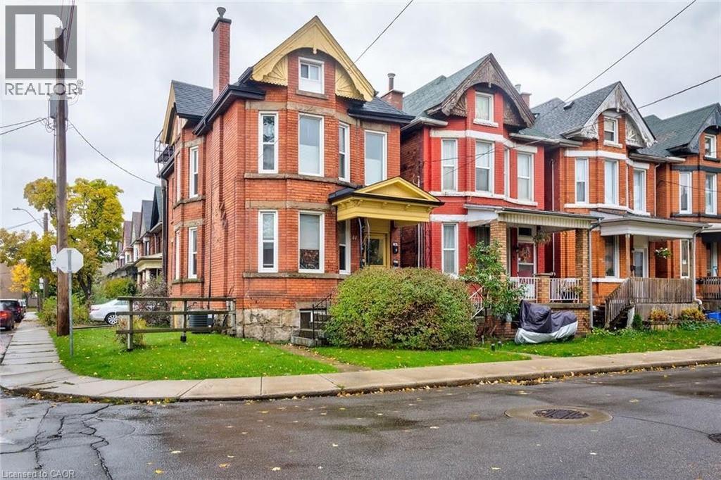 Victorian house with a chimney, brick siding, and covered porch - 44 Ashley Street, Hamilton, ON - Outdoor With Facade