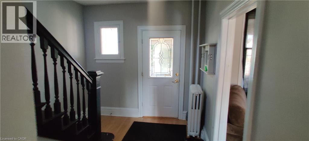 Foyer featuring radiator heating unit and light wood-type flooring - 170 Stewartdale Avenue, Hamilton, ON - Indoor Photo Showing Other Room