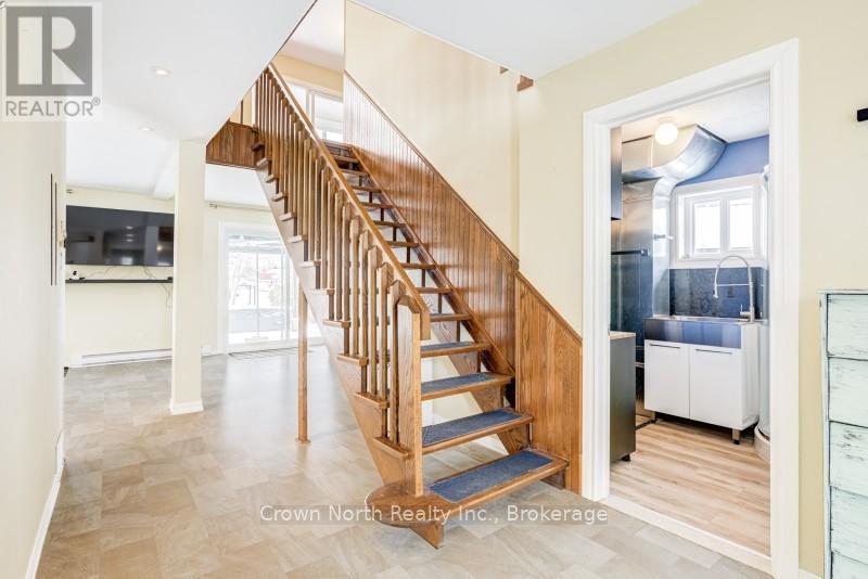 Solid Wood Staircase Open To Living Space - 39 Turtle Path, Ramara, ON - Indoor Photo Showing Other Room