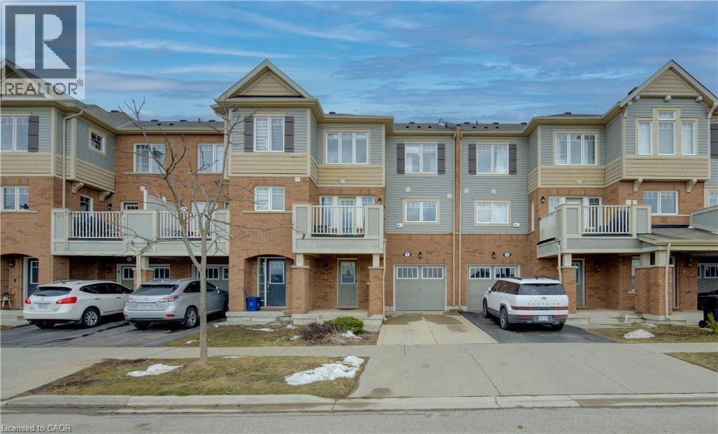 View of front of property with a balcony, driveway, brick siding, and a garage - 9 Outlook Terrace, Kitchener, ON - Outdoor With Balcony With Facade