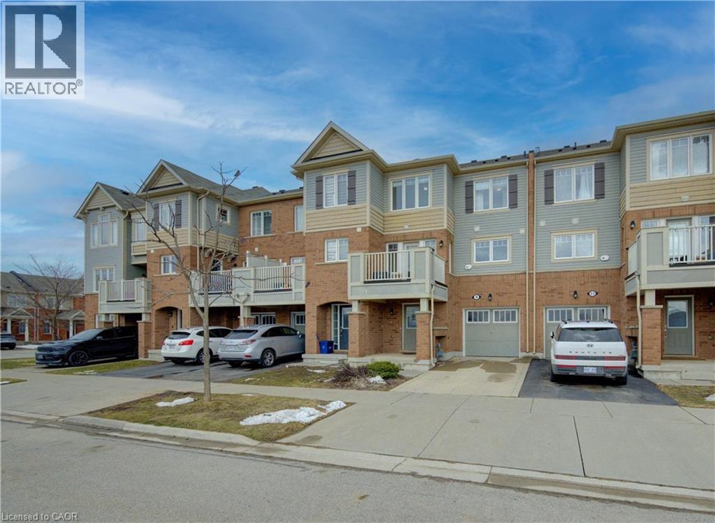 View of front of property featuring driveway, brick siding, a balcony, and an attached garage - 9 Outlook Terrace, Kitchener, ON - Outdoor With Balcony With Facade