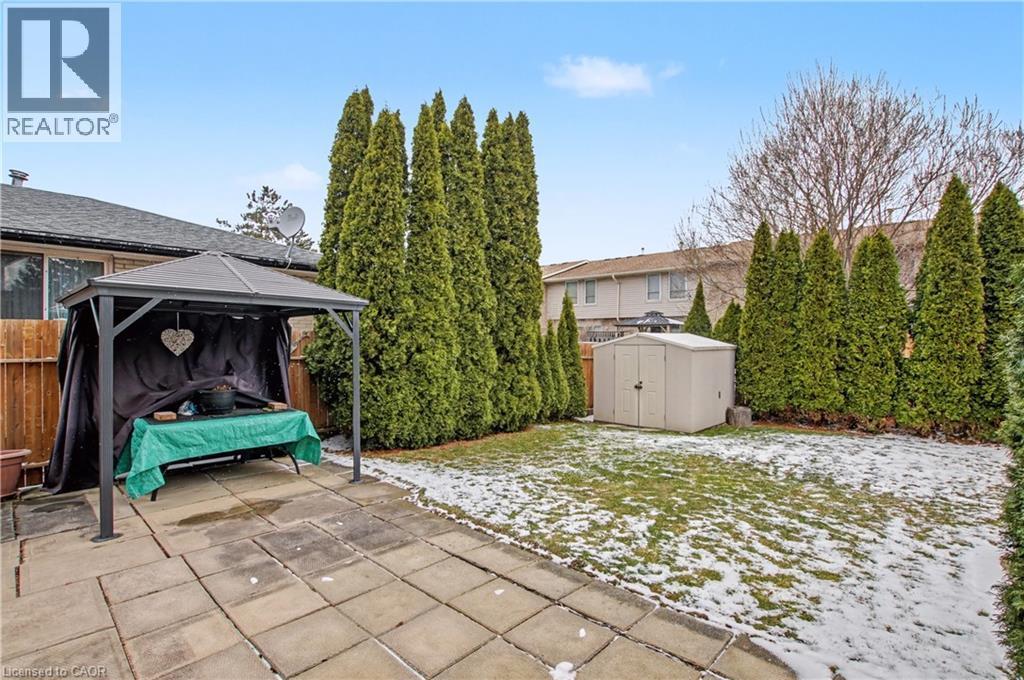 Fenced backyard featuring a storage unit, a gazebo, and a patio area - 21 Greystone Crescent, St. Catharines, ON - Outdoor