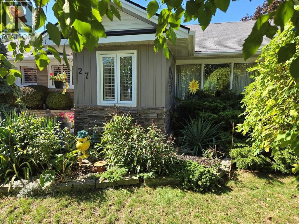 View of side of property featuring board and batten siding and stone siding - 27 Hepburn Avenue, St. Thomas, ON - Outdoor
