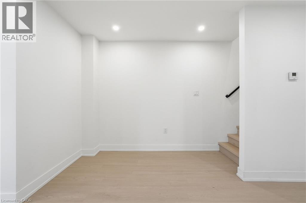 Staircase featuring wood finished floors and recessed lighting - 1278 Main Street E, Hamilton, ON - Indoor Photo Showing Other Room