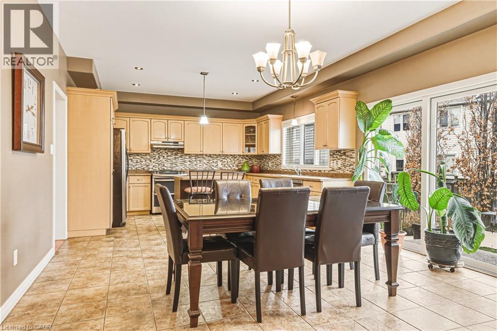 Dining space featuring hanging lights and light tile patterned flooring - 120 Valiant Circle, Hamilton, ON - Indoor Photo Showing Dining Room